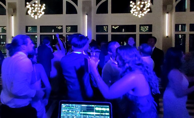 People Dancing At A Wedding In Blue Light